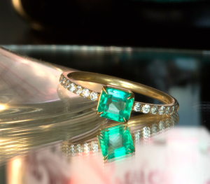 Unique designer emerald and diamond engagement ring 